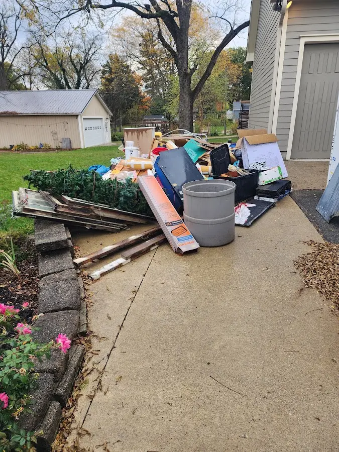 Dumpster being loaded with debris for Estate Cleanout Dumpster Rental in Spring Lake Heights